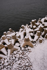 Concrete massive breakwaters on the sea coast to protect the coast from the destructive effects of sea waves. Concrete breakwater blocks