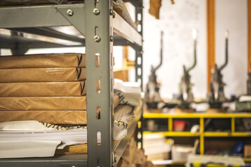Printing house warehouse and metal shelf with paper. Working process, printing indutry concept photo