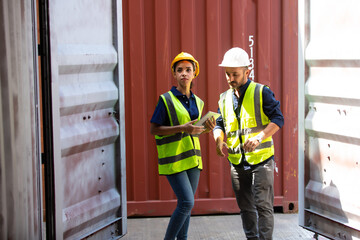 Fototapeta na wymiar Hispanic Man worker and woman Supervisor dock cargo checking and control loading Containers box at container yard port of import and export goods. Unity and teamwork concept