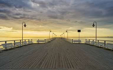 Wooden Pier in Gdynia Orlowo. Sunset on Baltic Sea.  