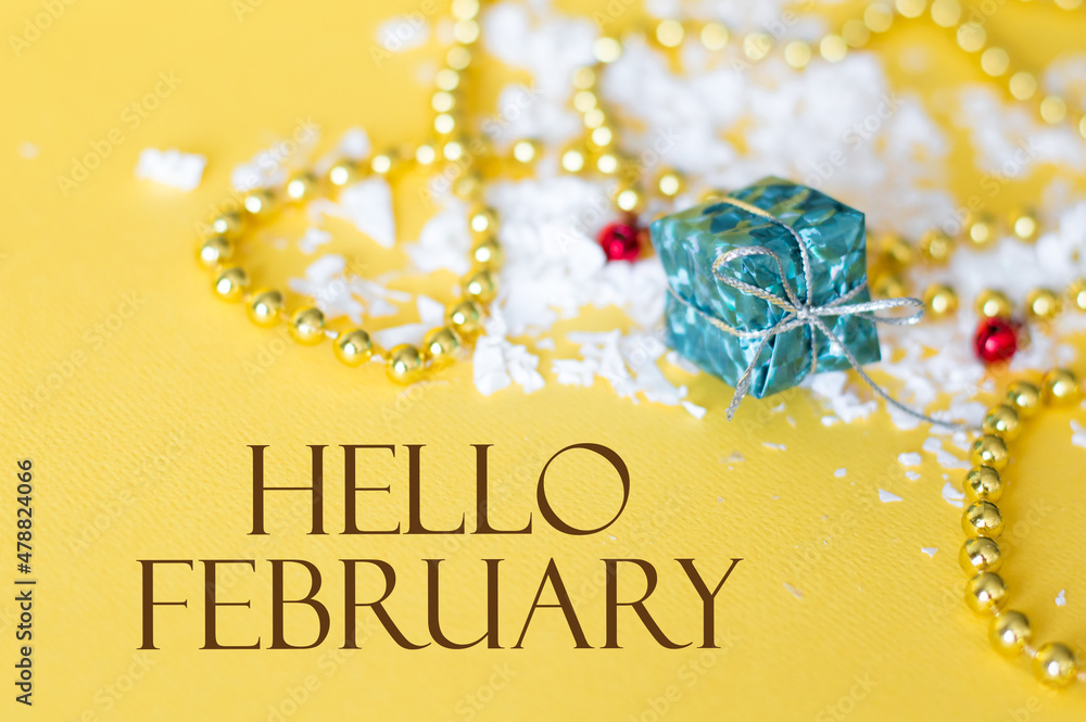 Poster hello february greeting card. yellow background with text space next to yellow beads and half-boxes 