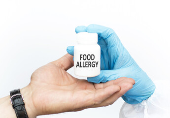 Food Allergy inscription on the label on a white jar in the hands of a doctor, which is torn into the hand of the patient, Medical concept