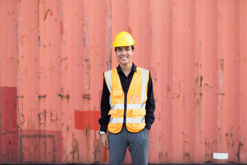 Marine and carrier insurance concept. Cargo container yard. Portrait Asian man engineer worker wearing hardhat safety helmet and vest working in  logistic shipping yard.