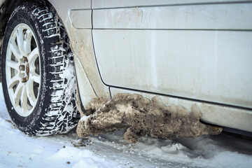 Ice on the bottom of the car after a snowy road