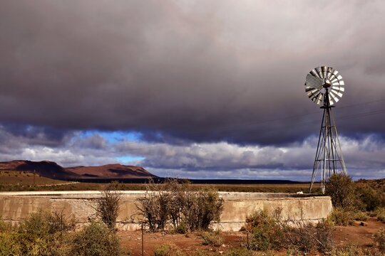 Windmill and water reservoir in the Karoo landscape in South Africa
