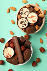Concept of sweets with chocolate candies on mint background