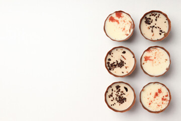 Flat lay composition with chocolate candies on white background