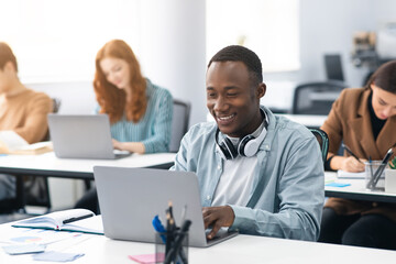 Group of international people using laptops in classroom
