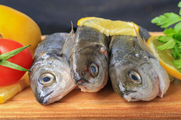 Freshly Caught Bogue Fish Or Boops Boops fish ready to be cooked on wooden cutting board : Turkish name Kupes fish