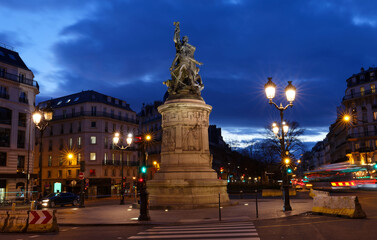 Fototapeta na wymiar Place de Clichy at night, Paris, France. Bronze statue of Marechal Moncey at the centre of the square.