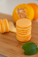 Mandarin macaroons on a wooden table.