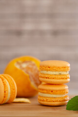 Mandarin macaroons on a wooden table.