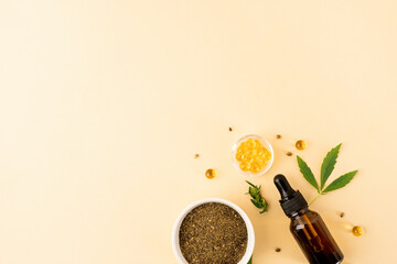 cbd oil and cannabis leaves cosmetics top view on orange background