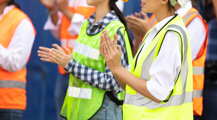 Unity and teamwork concept. Container worker audience applauding in morning brief meeting before going to work. Congratulation Celebrate success concept.