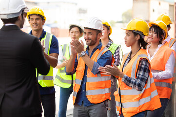 Unity and teamwork concept. Container worker audience applauding in morning brief meeting before...