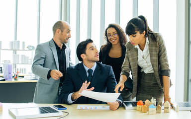 Caucasian smart successful businesspeople wearing formal suit, discussing, brainstorming, meeting in modern indoor office, talking about real estate investment and solar system. Teamwork concept.