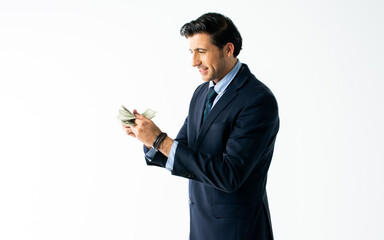 Portrait handsome rich Caucasian male businessman wearing formal suit, counting dollar banknote money with excitement, making surprising and happy face, standing on isolated white background cutout.