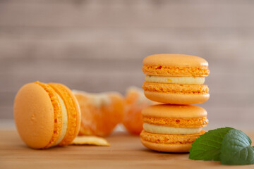 Mandarin macaroons on a wooden table.