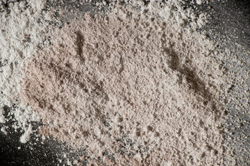 white powder on black background, flour sprinkled