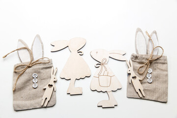 Frame for text. Wooden plywood figures of hares of different sizes, rag canvas bags with ears and...