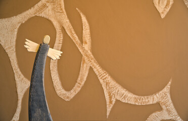 wooden painted angel on abstract blurry background, old handicraft figurines, background with...