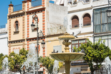 Stone fountain in the commercial and restaurant area of Plaza del Cabildo, Sanlucar de Barrameda, Cadiz Andalucia, Spain - obrazy, fototapety, plakaty