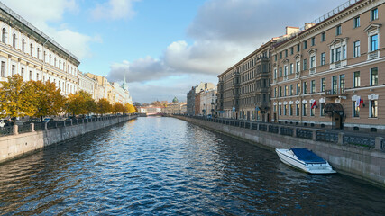 Naklejka premium view of the city canal and sports boat against the blue sky in St. Petersburg, Russia