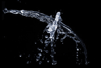 Full frame of the textures formed by the water jets to pressure with drops floating in the air on a black background