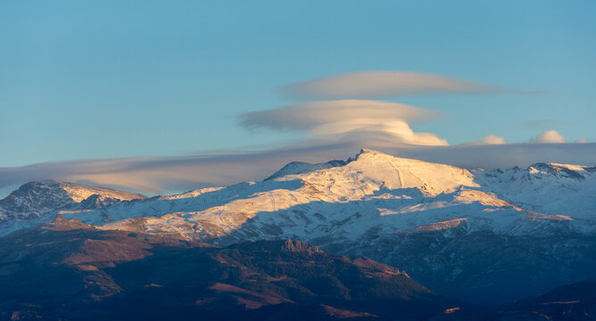 Spectacular lenticular clouds over the peaks of Sierra Nevada (Spain) at sunset in winter © Miguel Ángel RM