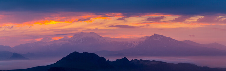 Purple sky over the mountains. Panorama copy space landscape.