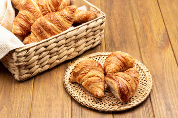 Croissants on wicker plate and in basket.