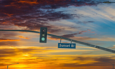 Sunset boulveard sign in Los Angeles under a scenic sky at dusk