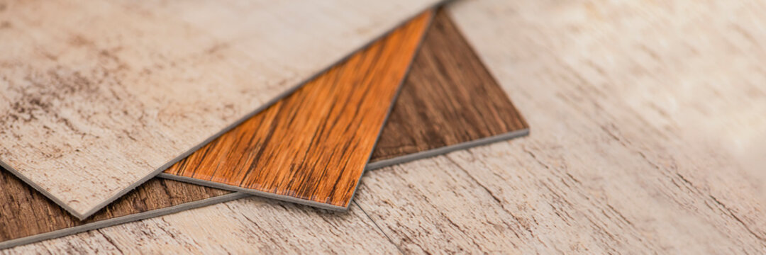 PVC industrial floors. Vinyl floors. The swatches are brown with a woody texture. Copy space