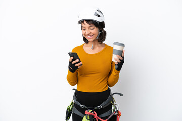 Young woman rock-climber woman isolated on white background holding coffee to take away and a mobile