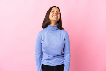 Fototapeta premium Young latin woman isolated on pink background laughing