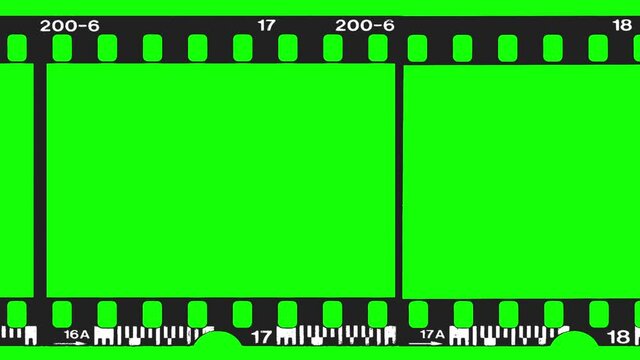 An empty black film strip moving in front of a green screen.