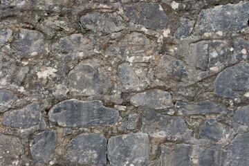 Antiguo muro de piedra gris, al aire libre