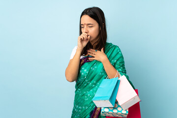 Young Indian woman with shopping bags coughing a lot