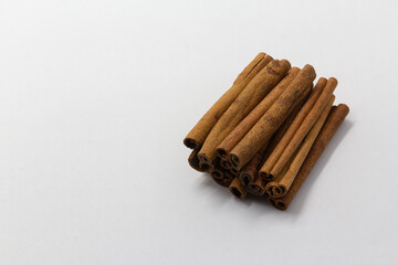 cinnamon sticks and anise stars on white background, healthy eating, copy space, horizontal