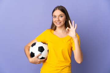 Young Lithuanian football player woman isolated on purple background showing ok sign with fingers