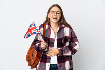 Young Lithuanian woman holding an United Kingdom flag isolated on white background smiling a lot