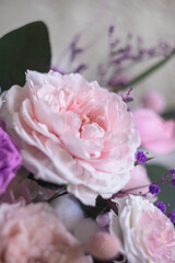 Beautiful spring Flowers in bouquet in pink and purpl color. Arrangement with Peonies roses. Flowers decor.