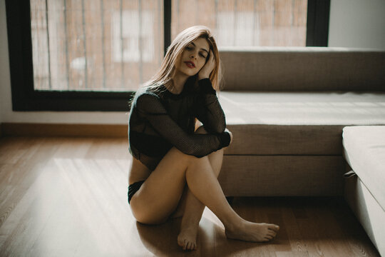 Portrait of a young woman with chronic venous insufficiency on her left leg