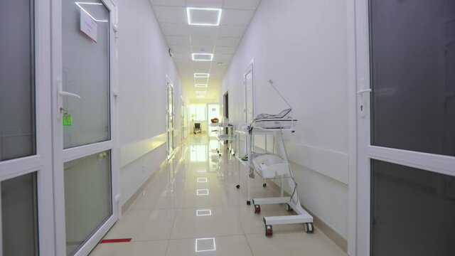 The camera zooms in on an empty wheelchair for the disabled. Wheelchair in the clinic corridor. A frame that simulates the loss. Interior of a modern clinic