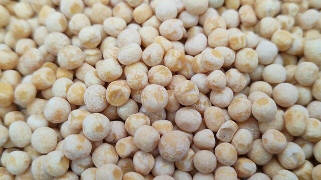 Whole grains of dry peas in close-up. Rotation.