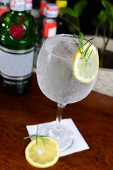 Tropical citric fruit drink served in an exotic glass with dehydrated fruits and ice