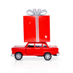 Isolated Red toy car with a large gift box on the roof