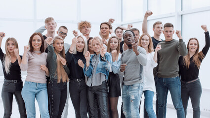 large group of happy young people showing their success