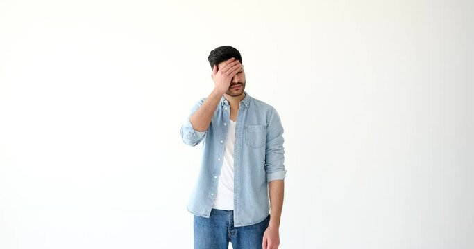 Man denying by shaking his head over white background