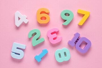 Colored numbers on a pink background. Mathematic topic. Back to school concept. Child education, learning mathematics and counting. Early childhood education.